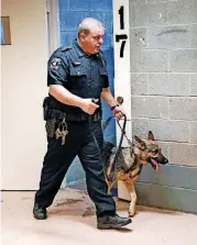  ??  ?? Sgt. Curtis Whittingto­n demonstrat­es how Han, his German shepherd K-9 partner, can detect contraband Wednesday at the Oklahoma County jail. Han, who has been at the jail a month, and Whittingto­n are the only K-9 contraband unit in the jail.