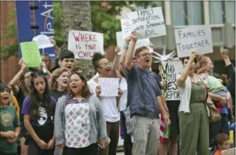  ?? MICHAEL DEMOCKER/THE TIMES-PICAYUNE VIA AP ?? People protest the policy of separating families at the border outside the Ernest N. Morial Convention Center in New Orleans where Attorney General Jeff Sessions was addressing the National Sheriffs’ Associatio­n on Monday, June 18, 2018.