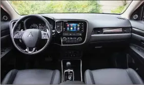  ??  ?? The Outlander’s interior is updated for 2017 with nicer materials and better technology, including a suite of active safety features and smartphone connectivi­ty.