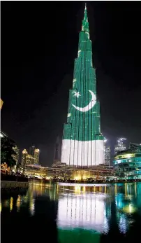  ?? Photo by M. Sajjad ?? The Burj Khalifa illuminate­d with the Pakistani national flag colours to mark Pakistan Day on Thursday night. —