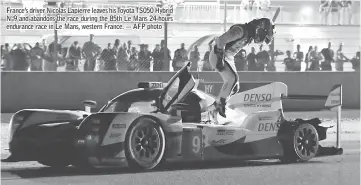  ??  ?? France’s driver Nicolas Lapierre leaves his Toyota TS050 Hybrid N°9 and abandons the race during the 85th Le Mans 24-hours endurance race in Le Mans, western France. — AFP photo