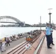  ?? RYAN PIERSE, GETTY IMAGES ?? Police patrol outside the Sydney Opera House in Australia on Wednesday.