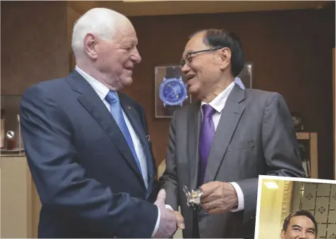  ??  ?? ALL SMILES Philippe Stern presents to Anthony Lim a Patek Philippe watch for his 80th birthday