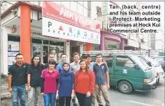  ??  ?? Tan ( back, centre) and his team outside i- Protect Marketing premises at Hock Kui Commercial Centre.