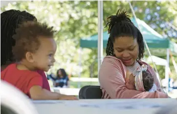  ?? JOHN J. KIM/CHICAGO TRIBUNE ?? Endia Williams feeds her 6-week-old daughter, Delilah, during an event hosted by the Chicago South Side Birth Center called “Latch & Stroll: Black Breastfeed­ing Week 2022” at Jackson Park in Chicago on Saturday.