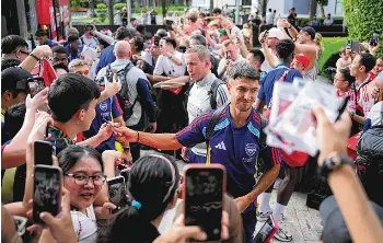  ?? ?? New Arsenal man Martin Zubimendi signing autographs for fans at W Singapore Sentosa Cove on July 20. The Spaniard will be an important addition to a midfield that includes Declan Rice and captain Martin Odegaard. ST PHOTO: MARK CHEONG
