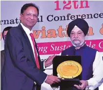  ??  ?? Civil Aviation Minister Hardeep Puri felicitati­ng SpiceJet Chairman Ajay Singh with the “Best Domestic Airline”, 2019 award at 12th Internatio­nal Conference cum Awards, Civil Aviation & Cargo.