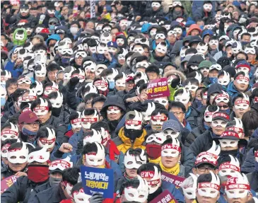  ??  ?? MASKED FURY: South Koreans attend an anti-government rally in central Seoul.