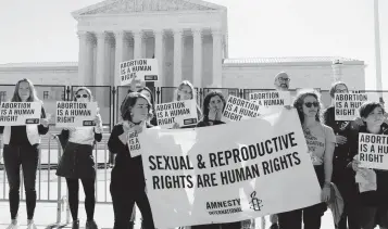  ?? JOSE LUIS MAGANA AP ?? Abortion rights activists protest outside of the U.S. Supreme Court, Wednesday, May 11, 2022 in Washington. A draft opinion suggests the U.S. Supreme Court could be poised to overturn the landmark 1973 Roe v. Wade case that legalized abortion nationwide, according to a Politico report.