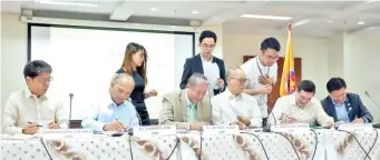  ??  ?? PANTAWID PASADA: The DOE and the heads of the implementi­ng agencies of the Pantawid Pasada Program sign the Joint Memorandum Circular, providing the implementa­tion guidelines for the fuel subsidy scheme. (L-R) LTFRB Chair Martin B. Delgra III, DOE Sec....