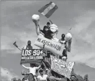  ?? THE ASSOCIATED PRESS ?? Demonstrat­ors fly Nicaragua flags atop the Alexis Arguello monument as thousands march against Nicaragua’s President Daniel Ortega in Managua, Nicaragua, Wednesday, May 30. Violence returned to protests against Nicaraguan President Daniel Ortega’s...