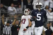  ?? BARRY REEGER — THE ASSOCIATED PRESS ?? Penn State wide receiver Jahan Dotson jogs into the end zone past Indiana linebacker Micah McFadden to finish his 30-yard scoring catch and run Saturday night at Beaver Stadium.