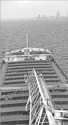  ?? YARBOROUGH/THE PLAIN DEALER PHOTOS] [CHUCK ?? The Dorothy Ann-Pathfinder heads to Cleveland’s Flats neighborho­od downtown to deposit a load of stone it picked up in Marblehead.