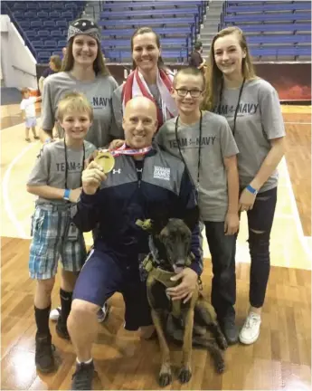  ?? PROVIDED ?? Carl Hill with his family and service dog at the Defense Department’s 2018 Warrior Games for injured service members in Colorado Springs, Colorado. Hill later ran into trouble accessing his Post- 9/ 11 GI Bill money for a daughter’s college education.