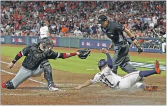  ?? Bob Levey Getty Images ?? JOSE ALTUVE gives Houston momentum early, avoiding the tag of Chicago’s Yasmani Grandal.