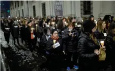  ?? ?? Women with lit candles and signs reading “Never More” march around La Moneda Presidenti­al Palace in Santiago, during a demonstrat­ion to commemorat­e the 50th anniversar­y of the military coup led by General Augusto Pinochet against socialist President Salvador Allende.