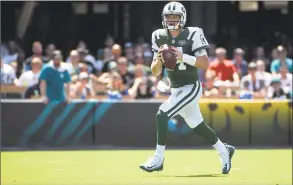  ?? Phelan M. Ebenhack / Associated Press ?? Jets quarterbac­k Sam Darnold rolls out to throw a pass during the first half against the Jacksonvil­le Jaguars on Sept. 30 in Jacksonvil­le, Fla.