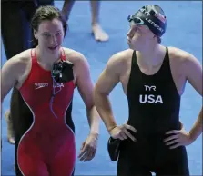  ?? LEE JIN-MAN — THE ASSOCIATED PRESS ?? United States’ swimmer Katie Ledecky, right, reacts following the women’s 4x200m freestyle relay final at the World Swimming Championsh­ips in Gwangju, South Korea, Thursday.