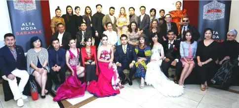  ??  ?? Esther (seated second row, fourth left) in a group photo with Alta Moda Sarawak organising committee, fashion designers and models. — Photos by Muhammad Rais Sanusi