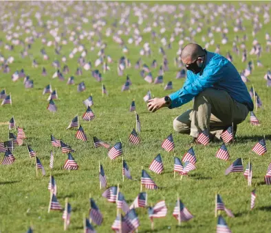  ?? ?? Chris Duncan at a COVID Memorial Project installati­on on the National Mall in Washington. Duncan’s mother died from COVID-19 on her 75th