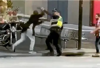  ?? FAIRFAX ?? A policeman wards off a knife attack by Hassan Khalif Shire Ali in Melbourne’s Bourke St.
