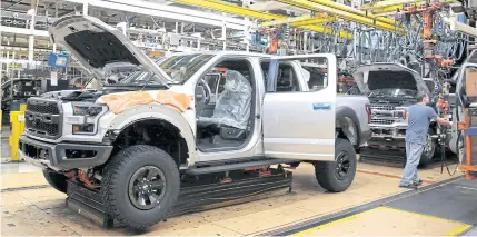  ?? REUTERS ?? A 2018 F150 pickup truck moves down the assembly line at Ford Motor Co’s Dearborn Truck Plant during the 100-year celebratio­n of the Ford River Rouge Complex in Michigan on Sept 27, 2018.