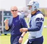  ?? TONY GUTIERREZ/ JOURNAL ?? Cowboys coach Jason Garrett walks off the field with quarterbac­k Dak Prescott after practice Wednesday. With Tony Romo gone, the team belongs to Prescott.