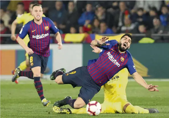  ?? — AP ?? Hey!: Barcelona forward Luis Suarez is tackled by Villarreal’s Ramiro Funes Mori during the La Liga match at the Ceramica Stadium on Tuesday.