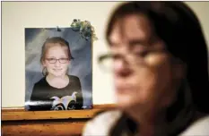  ?? AP photo ?? Patti Burt poses near a photo of her granddaugh­ter, 9year-old Ava Lerario, in Cherry Hill, N.J. Burt's daughter Ashley Belson, Ava, and Ava’s father, Marc Lerario, were found shot to death in May.