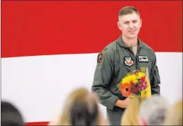  ?? Morgan Lieberman ?? Las Vegas Review-journal Lt. Col. Michael Blauser approaches his wife with a bouquet Tuesday at Nellis
Air Force Base during an activation ceremony for an F-35A Lightning II aircraft.