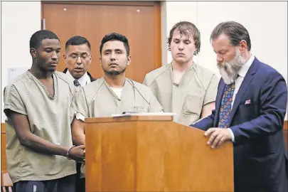  ?? [JOSHUA A. BICKEL/DISPATCH] ?? Ramon Corona Montalvo, center, listens as attorney Scott Culbert speaks at his arraignmen­t Friday in Franklin County Common Pleas Court. Montalvo, suspected of being a drug kingpin, was brought to court handcuffed to other prisoners who are not...