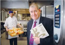  ?? PROVIDED TO CHINA DAILY ?? Michelin-starred chef Bill Brogan with his caterer’s guide to Chinese cuisine.