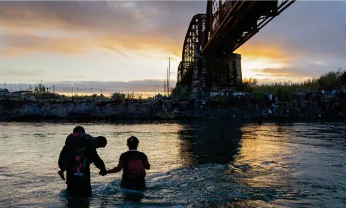  ?? Photograph: John Moore/Getty Images ?? An family wades through the Rio Grande while crossing from Mexico into the United States on 30 September 2023 near Eagle Pass, Texas.