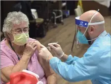  ?? PETE BANNAN - MEDIANEWS GROUP ?? CVS Pharmacist William Hallock gives the Pfizer BioNTechCO­VID-19 vaccine to Kendel-Crosswoods Communitie­s staff member Georgie Stoker Friday morning. Nearly 200 staff and 90 acute care residents of the facility received the first dose of the vaccine.