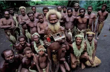  ??  ?? ABOVE: The villagers of Yaohnanen. BELOW: Prince Philip poses in 1980 with the pig-killing club sent him by the people of Tanna.