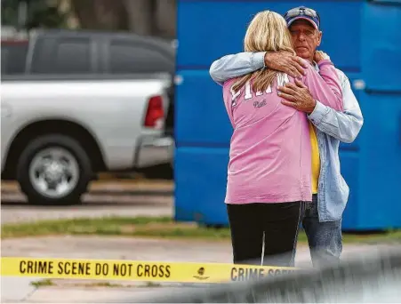  ?? Karen Warren / Houston Chronicle ?? Tim Miller with Texas Equusearch hugs a family member of Kirsten Fritch after searching in a wooded area in Texas City Thursday.