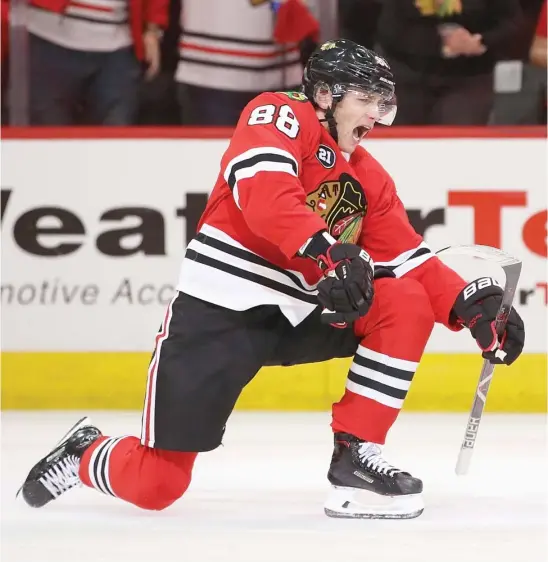  ?? GETTY IMAGES ?? Hawks star Patrick Kane starts the celebratio­n after scoring late in the third period Sunday against the Red Wings. He has at least one point in 14 consecutiv­e games.