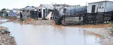  ?? PICTURE: PHANDO JIKELO ?? AWASH: The areas between the shacks at Siqalo informal settlement near Mitchells Plain were badly flooded after the severe storm struck this week.