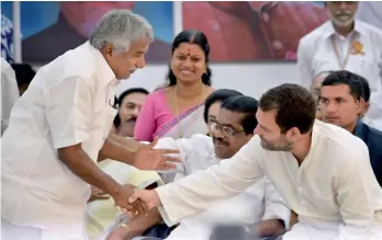  ?? — PTI ?? Congress vice- president Rahul Gandhi shakes hands with Kerala chief minister Oommen Chandy at the KPCC extended executive meeting in Thiruvanan­thapuram on Wednesday.