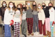  ?? Contribute­d photo ?? From left, Eastern Middle School students Anna Lenschow, Ellery Talbot, Kathryn Cole, teacher Megan Wax, Maddie Young, Harriet Franks, Belle Nichols and Leighton Collier mark PJ Day by wearing their pajamas to school. The fundraiser helps kids battling cancer at Connecticu­t Children’s Medical Center.