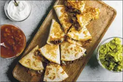  ??  ?? Cheesy ground beef quesadilla­s.