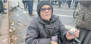  ?? Picture: REUTERS/TOM BALMFORTH ?? SEEKING: Anna Voskoboini­k holds up a picture of her son, who she says was arrested by Russian occupation forces three months ago, in Kherson, Ukraine earlier this month.