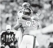  ?? JOE MAHONEY/ASSOCIATED PRESS ?? Panthers quarterbac­k Cam Newton is hit by defensive end Jared Crick (93) in the Broncos’ win Thursday night.