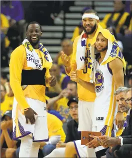  ?? EZRA SHAW — GETTY IMAGES ?? Draymond Green, JaVale McGee and Stephen Curry smile on the bench in the final moments of a victory during the 2016-17 championsh­ip season.