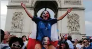  ?? THIBAULT CAMUS ?? People react on the Champs Elysees avenue with the Arc de Triomphe on background, after France defeated Croatia in the final match of the World Cup,