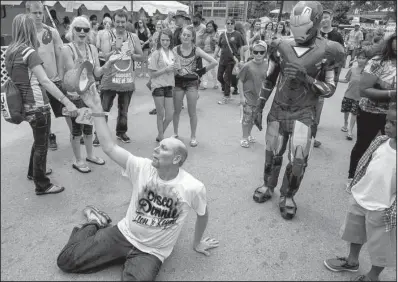  ?? Arkansas Democrat-Gazette/BENJAMIN KRAIN ?? A Little Rock man who goes by the name of Disco Donnie dances in a crowd Saturday afternoon at Riverfest.