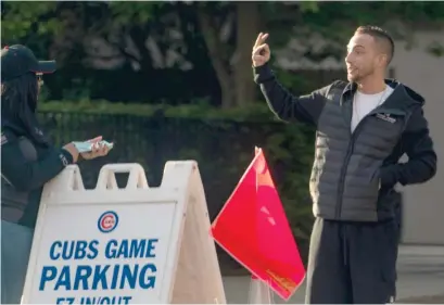  ??  ?? Premium 1 Parking owner Dylan Cirkic at a CPS-owned lot at 3830 N. Southport Ave. during a Cubs game Monday night.