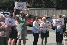  ?? Becky Bohrer / Associated Press 2019 ?? Protesters gathered outside Sen. Lisa Murkowski's office in Juneau, Alaska, last year to protest the proposed Pebble Mine.