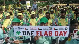  ??  ?? Workers celebrate UAE Flag Day at Zaabeel Park during an event organised by the Dar Al Ber Society and the Dubai Municipali­ty.