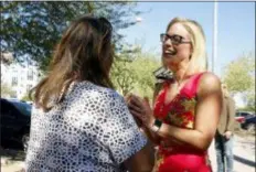  ?? RICK SCUTERI - THE ASSOCIATED PRESS ?? U.S. Senate candidate Kyrsten Sinema, D-Ariz., speaks to a supporter at the Barton Barr Central Library, Tuesday in Phoenix. Sinema and Republican challenger Martha McSally are seeking the senate seat being vacated by Jeff Flake, R-Ariz., who is retiring in January.